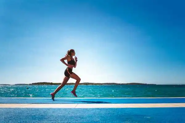 Woman running showing strong leg muscle Welford on Avon